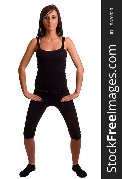 A young woman dressed in black gym wear exercising. A young woman dressed in black gym wear exercising.