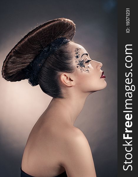 Portrait of beautiful girl with coiffure disc on grey. Portrait of beautiful girl with coiffure disc on grey