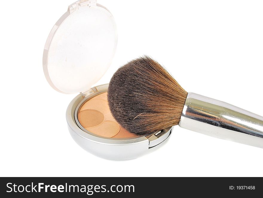 Cosmetic brush and powder makeup isolated on the white background.