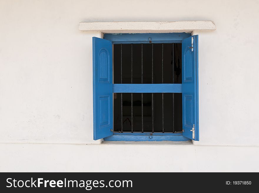 An old blue window and white wall in an Indian Village