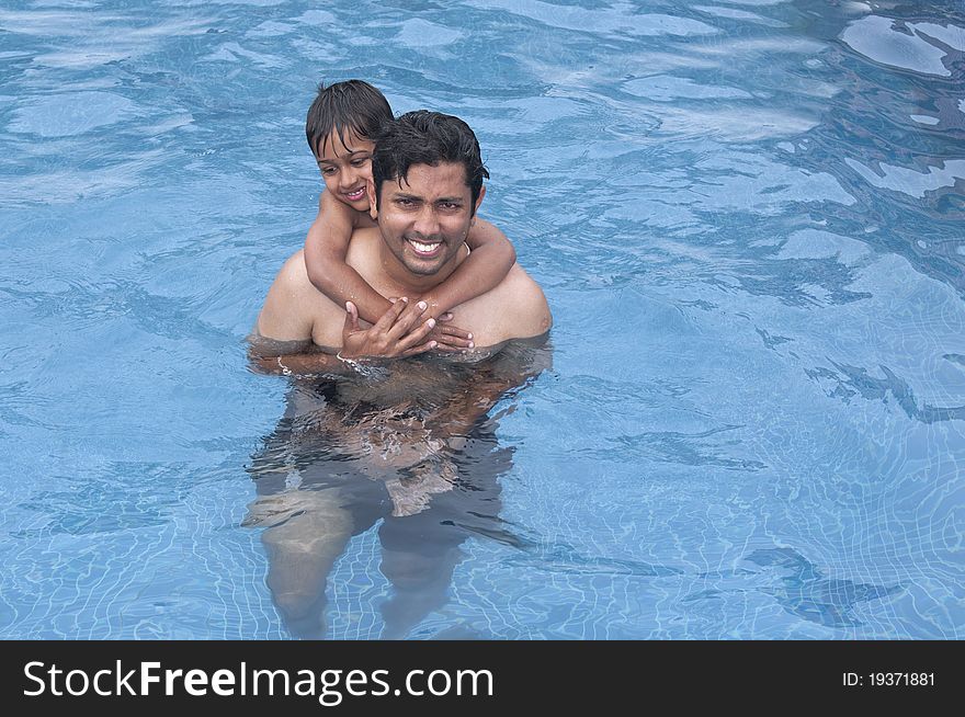 Father and Son having fun at the resport pool. Father and Son having fun at the resport pool