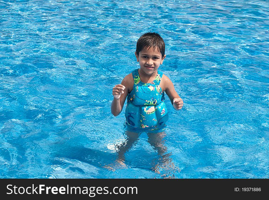 A handsome Indian kid playing in the pool. A handsome Indian kid playing in the pool