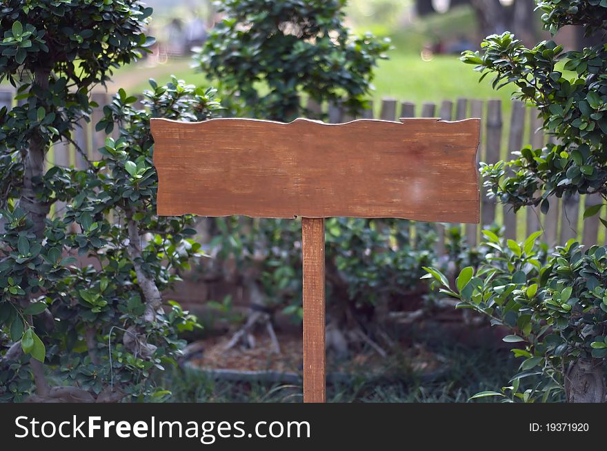 A wooden board on a local park with space for text