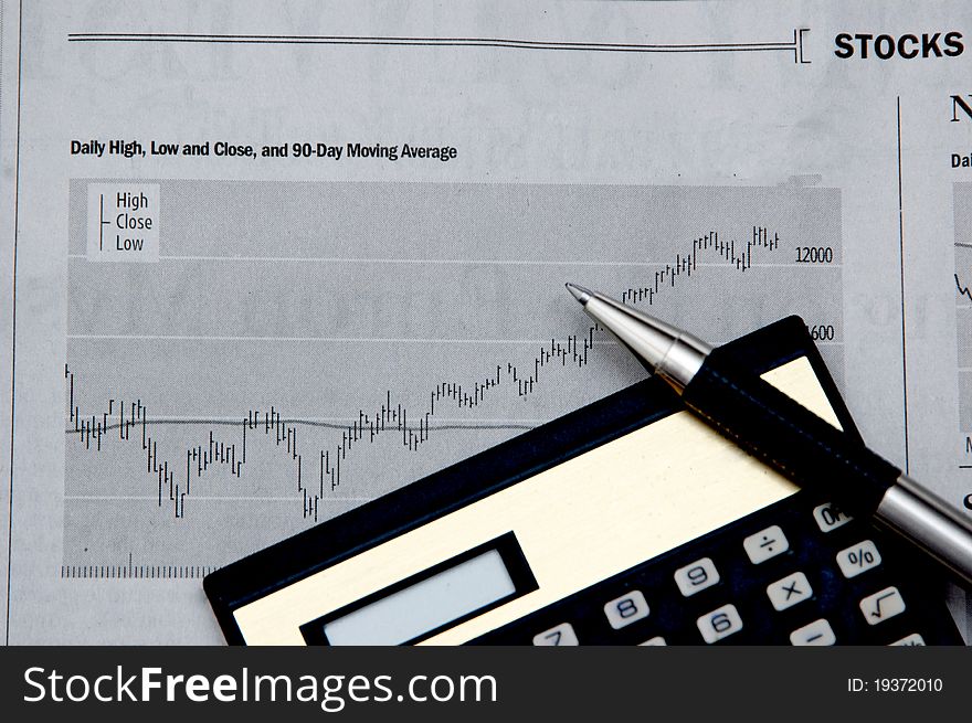 Rising stocks and calculator indicating business finance growth