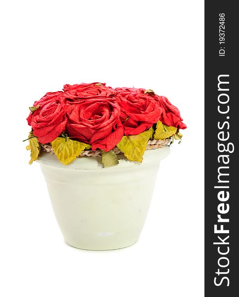 Artificial red rose flowers in a pot isolated on a white background. Artificial red rose flowers in a pot isolated on a white background