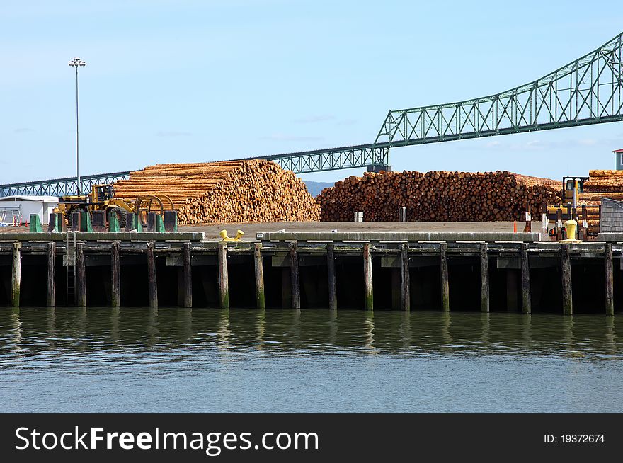 Pile Of Logs On Decks & The Astoria Bridge, OR.