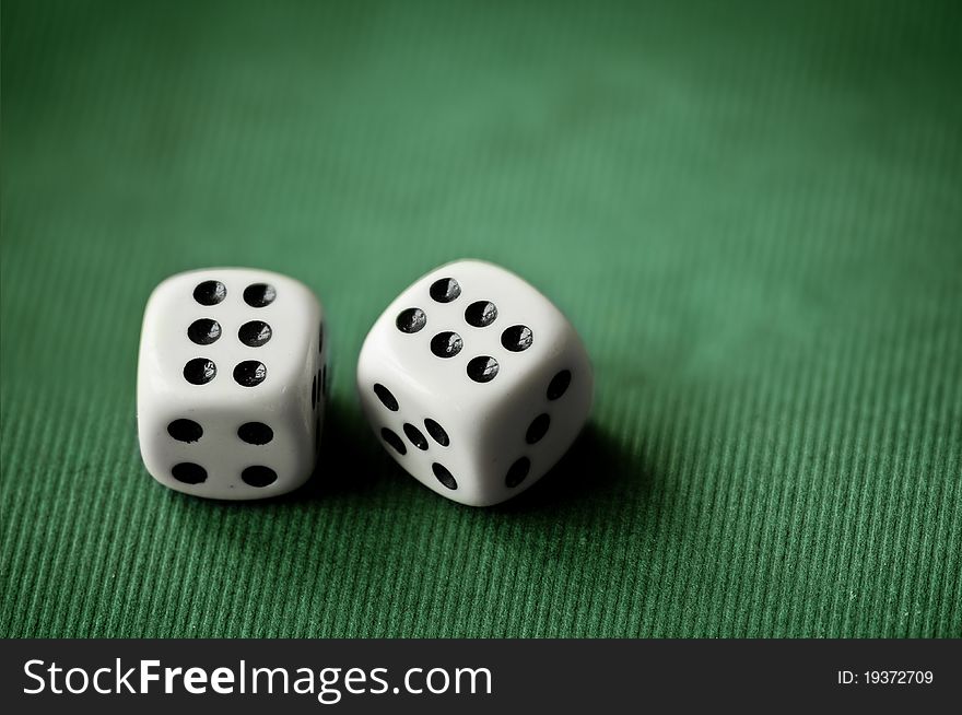 Close up with a pair of dices on green background