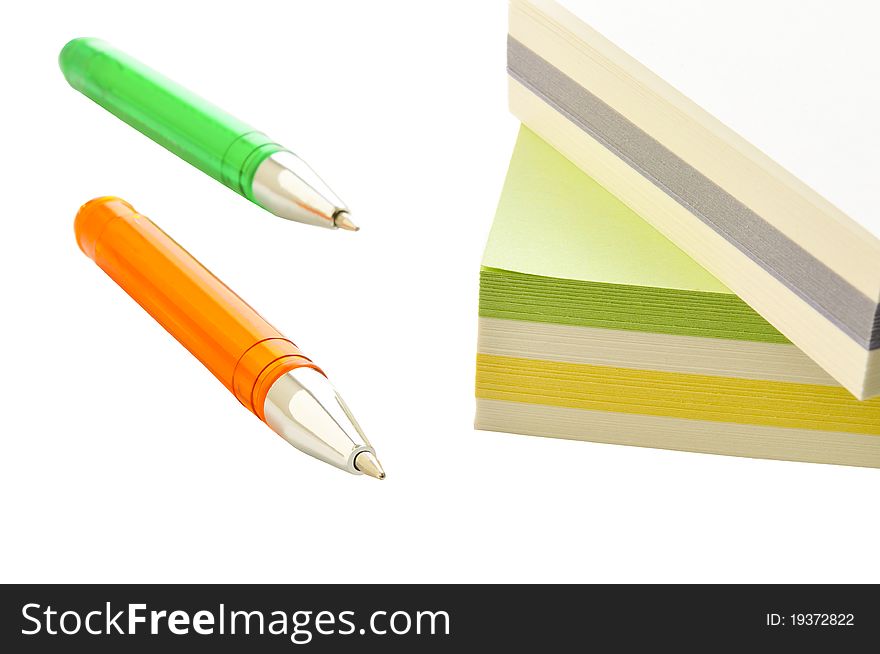 Ball pens and paper for records on the white isolated background