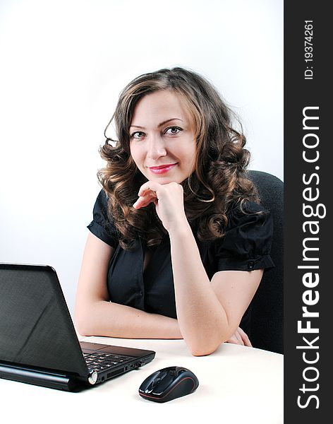 Young successful woman working at desk with laptop