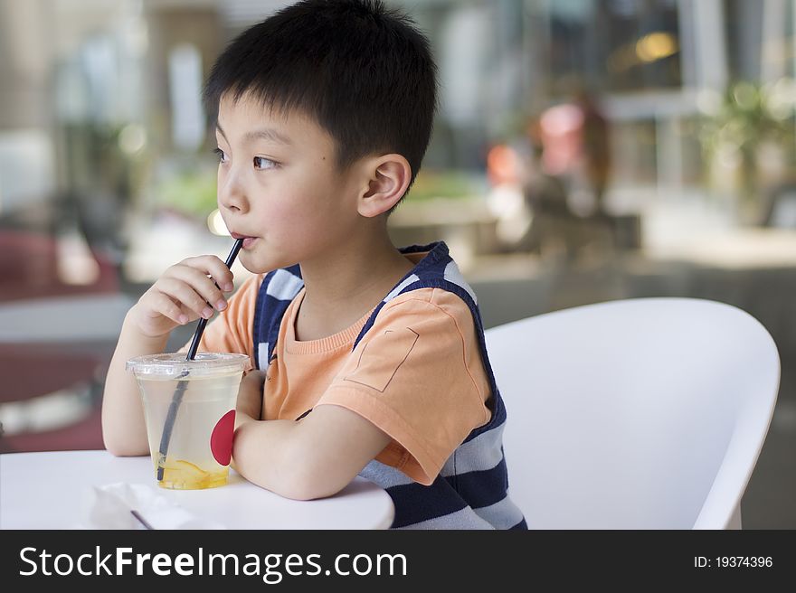 A Chinese boy drinking at a cafe