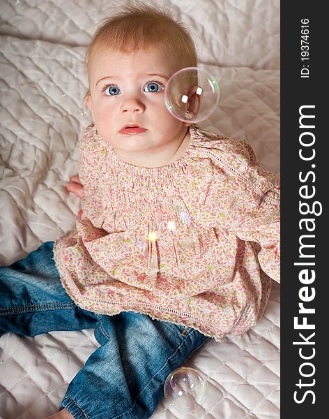 Closeup portrait of little cute baby girl with bubbles. Closeup portrait of little cute baby girl with bubbles