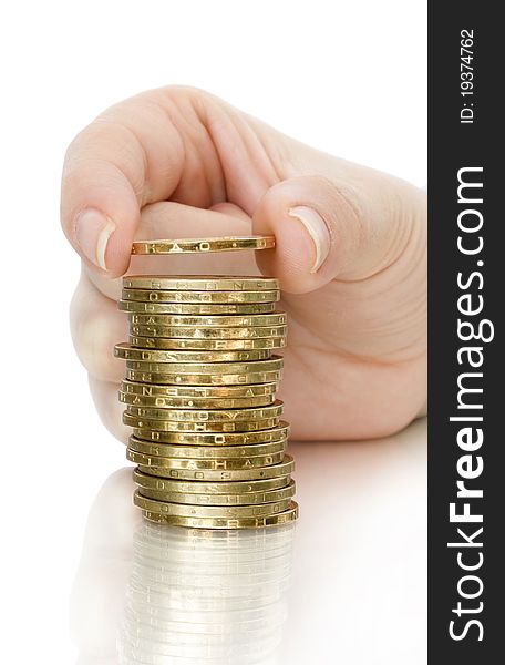 Stack of coin and coin in finger with reflection