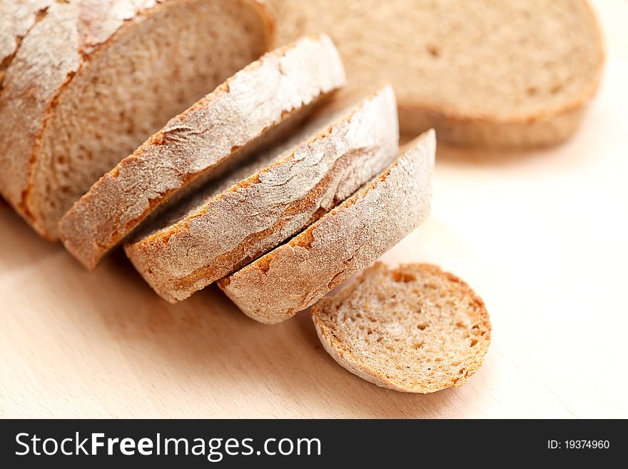 Sliced whole grain bread on wooden bread board