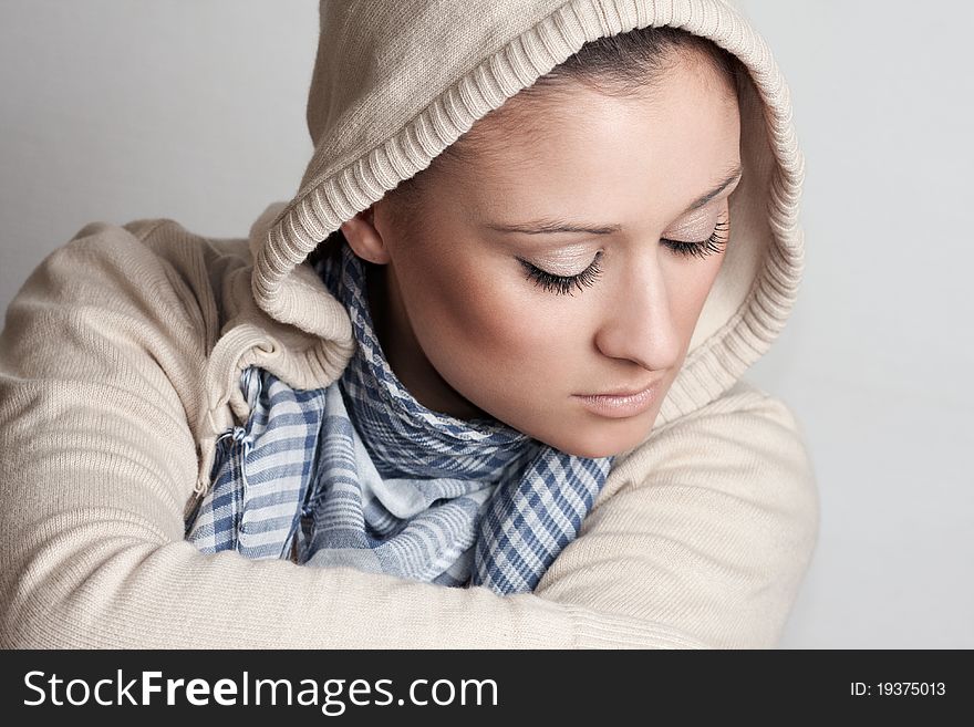 Shoot of a beautiful and sensual woman wearing a hood and looking down. Shoot of a beautiful and sensual woman wearing a hood and looking down