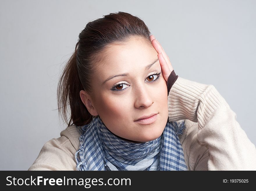 Portrait of a beautiful woman wearing a blue scarf, looking at cam and smiling. Portrait of a beautiful woman wearing a blue scarf, looking at cam and smiling