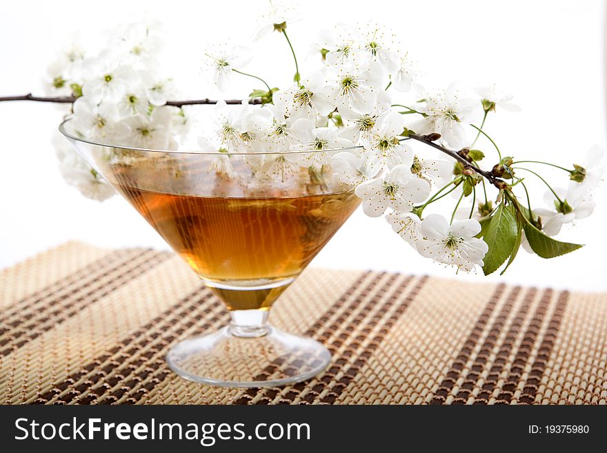 Bowl green tea and a branch with colors on a support. Bowl green tea and a branch with colors on a support