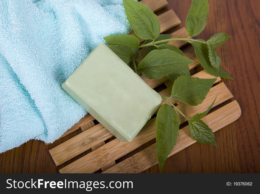 Sanitary articles and green sprout on a wooden shelf