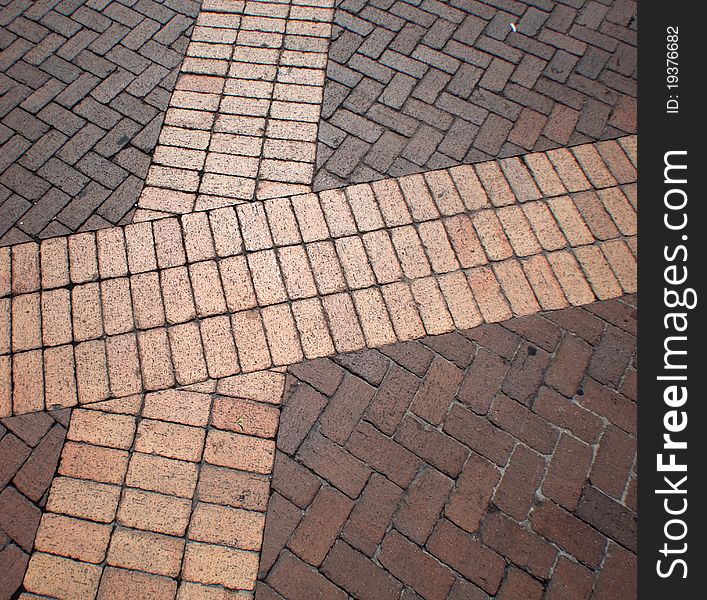 Different tones of bricks laid out in a decorative fashion. Different tones of bricks laid out in a decorative fashion