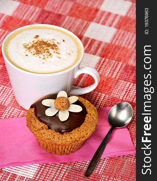 Breakfast concept: muffin, cup of coffee and spoon