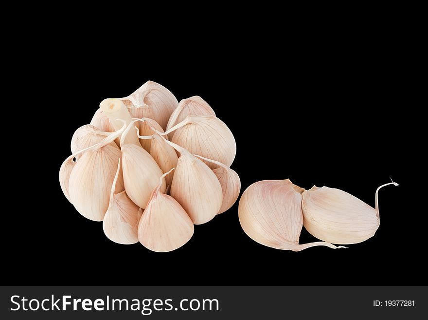 Garlic bulb and cloves isolated on  black  background.