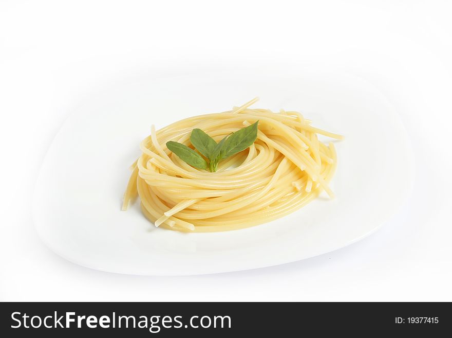 Portion of spagetti in a dish on a white background. Portion of spagetti in a dish on a white background