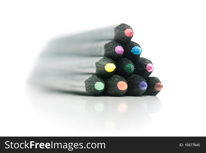Black coloured pencils bundled as pyramid, on white background