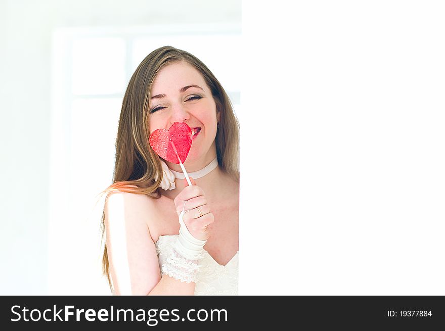 Portrait of the young bride with a candy