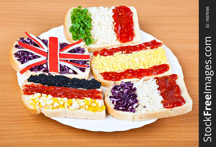 Sandwiches with flags of five countries on plate