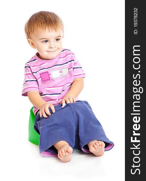 A boy sitting on the pot. Isolated on a white background