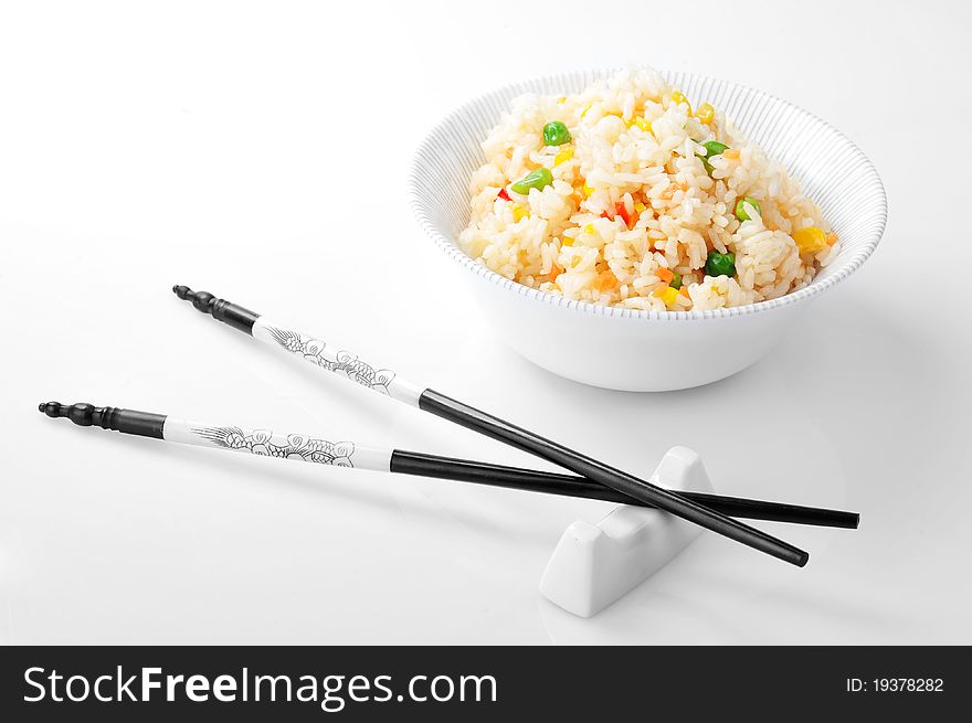 Bowl with rice and chopsticks close up