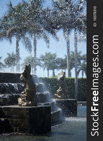 Water sprays and flows over the fountain brick work