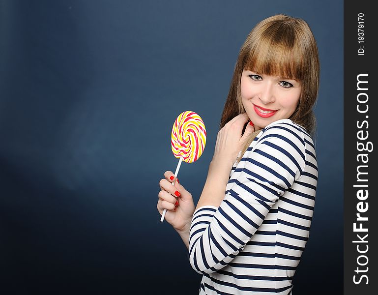 Cute smiling girl holding a lollipop. Cute smiling girl holding a lollipop