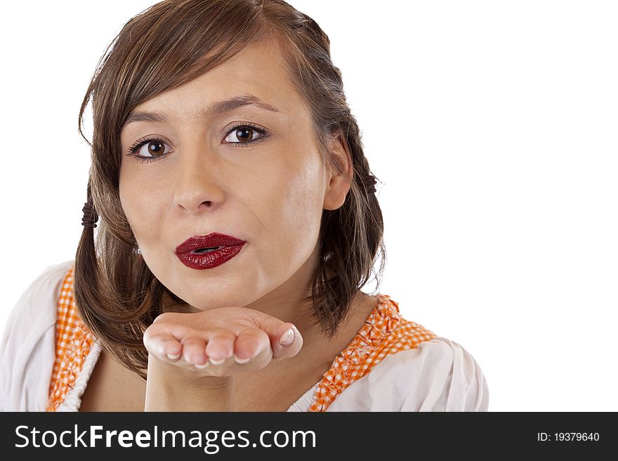 Closeup of a young pretty woman in dirndl blowing a kiss.Isolated on white background. Closeup of a young pretty woman in dirndl blowing a kiss.Isolated on white background.