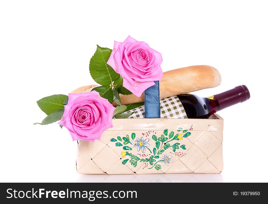 A romantic picnic with roses and wine isolated over white. A romantic picnic with roses and wine isolated over white