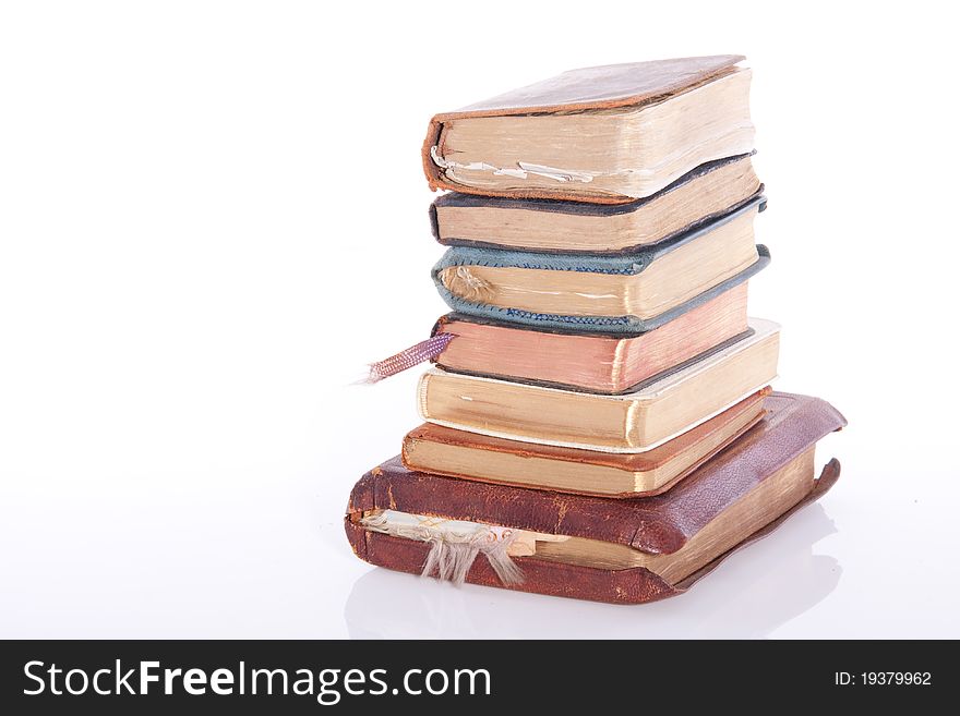 A stack of old books isolated over white background