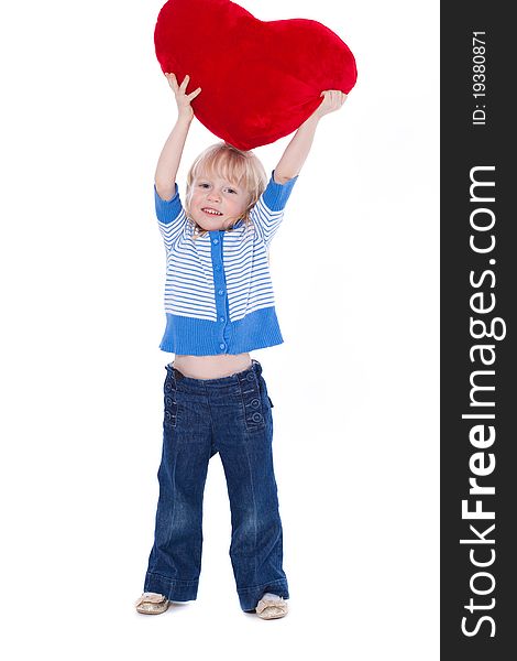 Cute child with raised red heart looking at camera