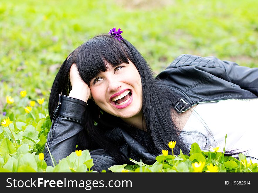 Single beautiful young woman relaxing at the park