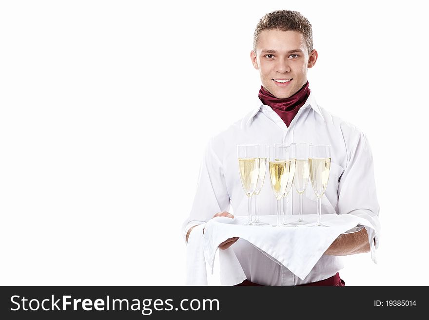 The young waiter with a tray with glasses of champagne on a white background