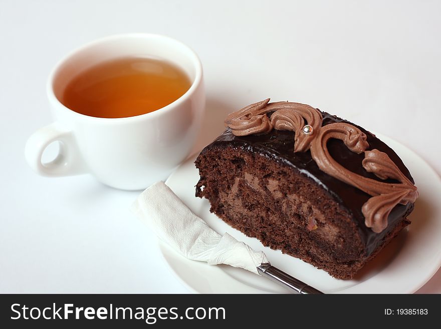 Cake on the dish, and cup of tea. Cake on the dish, and cup of tea