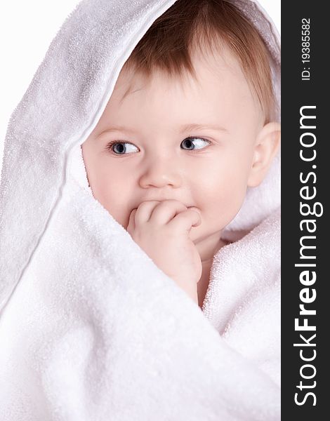 A small child in a white towel. A small child in a white towel