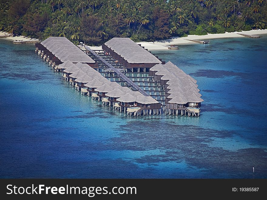 An aerial view of Water Villas on a coral reef. An aerial view of Water Villas on a coral reef
