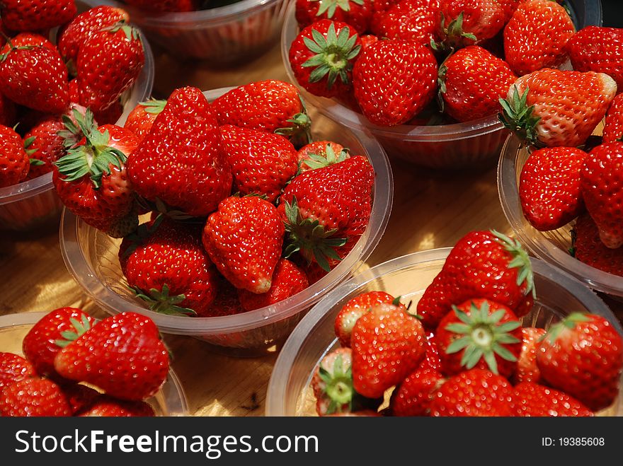 Several plates of fresh strawberry in a market. Several plates of fresh strawberry in a market.