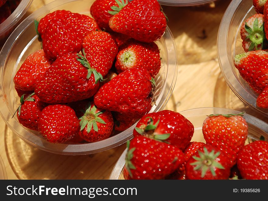Plates of fresh strawberry in a market