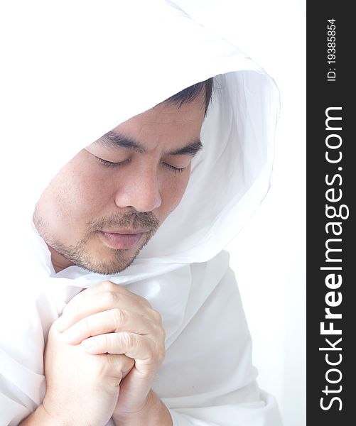 Asian man in white dress is praying. Asian man in white dress is praying