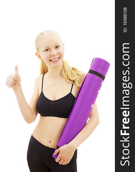 Happy beautiful sport girl standing with thumb up and holding purple mat in black clothes. Happy beautiful sport girl standing with thumb up and holding purple mat in black clothes.