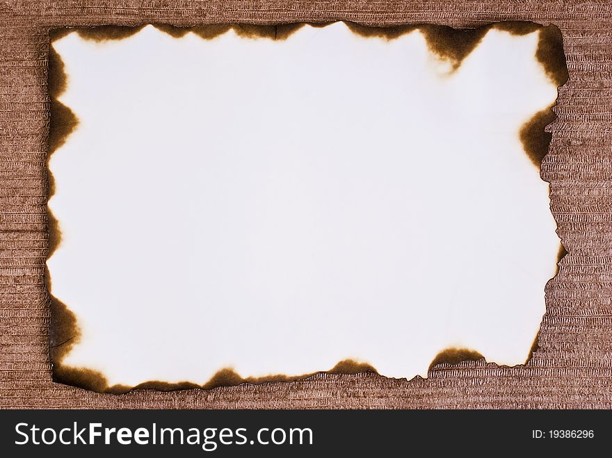 Burned paper on brown background