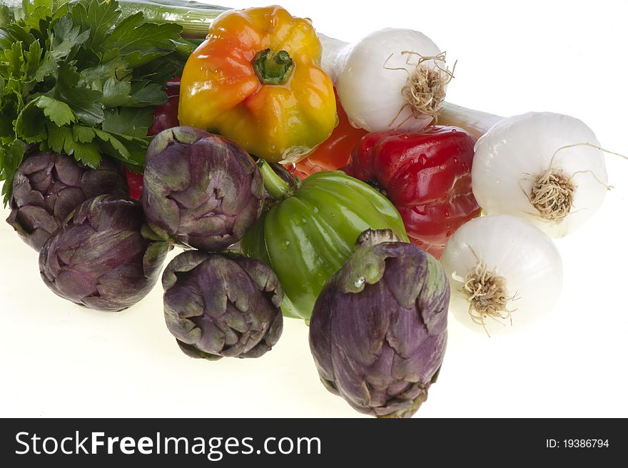 Small exotic peppers and artichokes on a white background