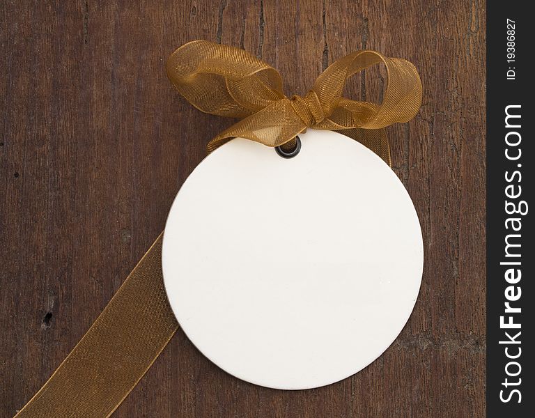 With transparent brown bow on the wooden background. With transparent brown bow on the wooden background