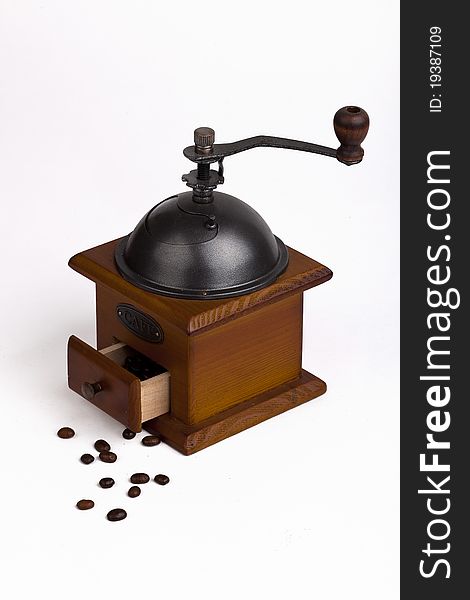 coffee grinder with coffee beans on white background