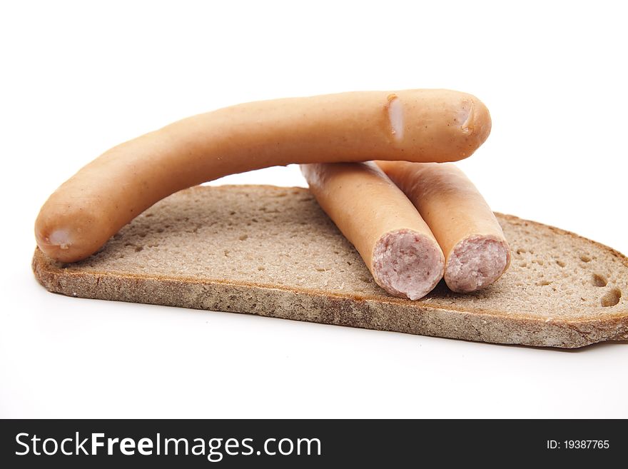 Meat sausage with bread onto white background